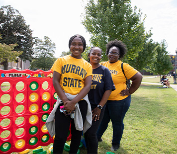 A Racer family enjoys giant Connect 4 at Family Weekend.