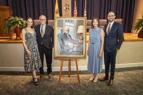 Jackson family pictured with Dr. Jackson's portrait
